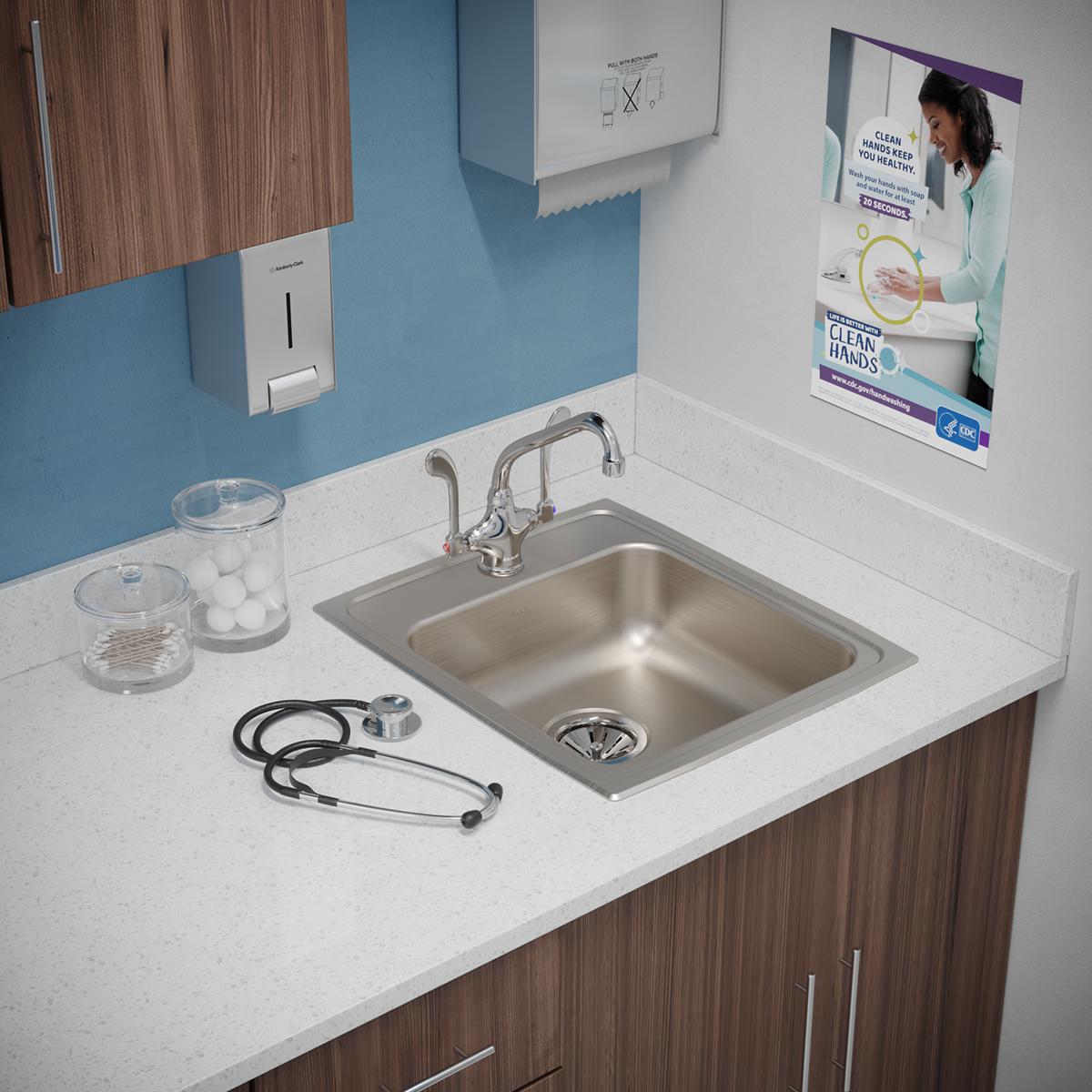 Stainless steel square drop-in sink with single faucet hole mounted in white countertop with chrome faucet.