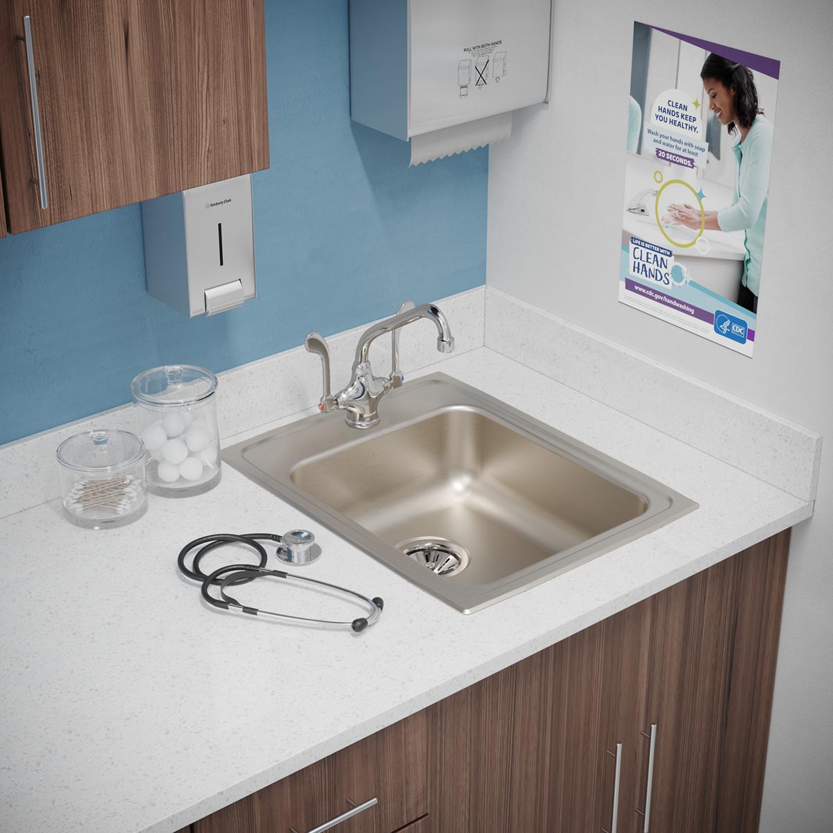Stainless steel drop-in sink with single bowl and one faucet hole, installed in white countertop with chrome faucet.