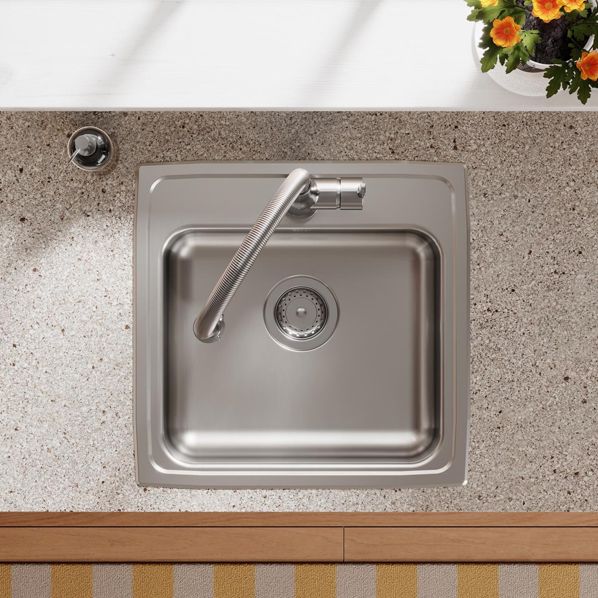 Stainless steel drop-in sink with single bowl, drain strainer, and chrome faucet installed in countertop.
