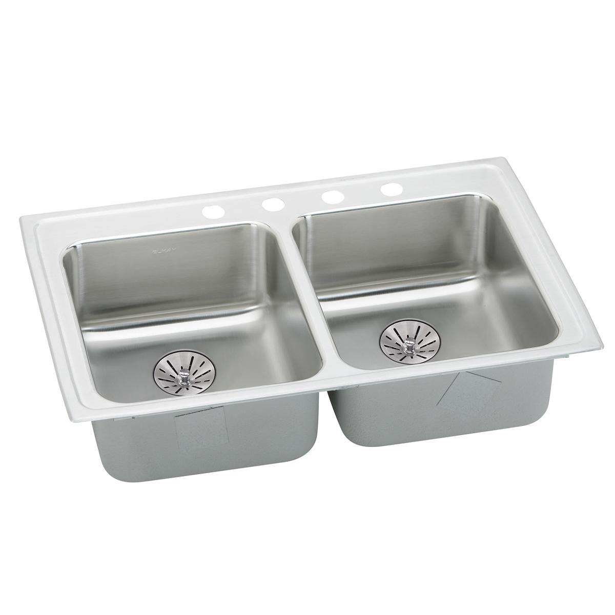 Stainless steel double bowl drop-in sink with white rim, drain strainers, and faucet holes across the top edge.