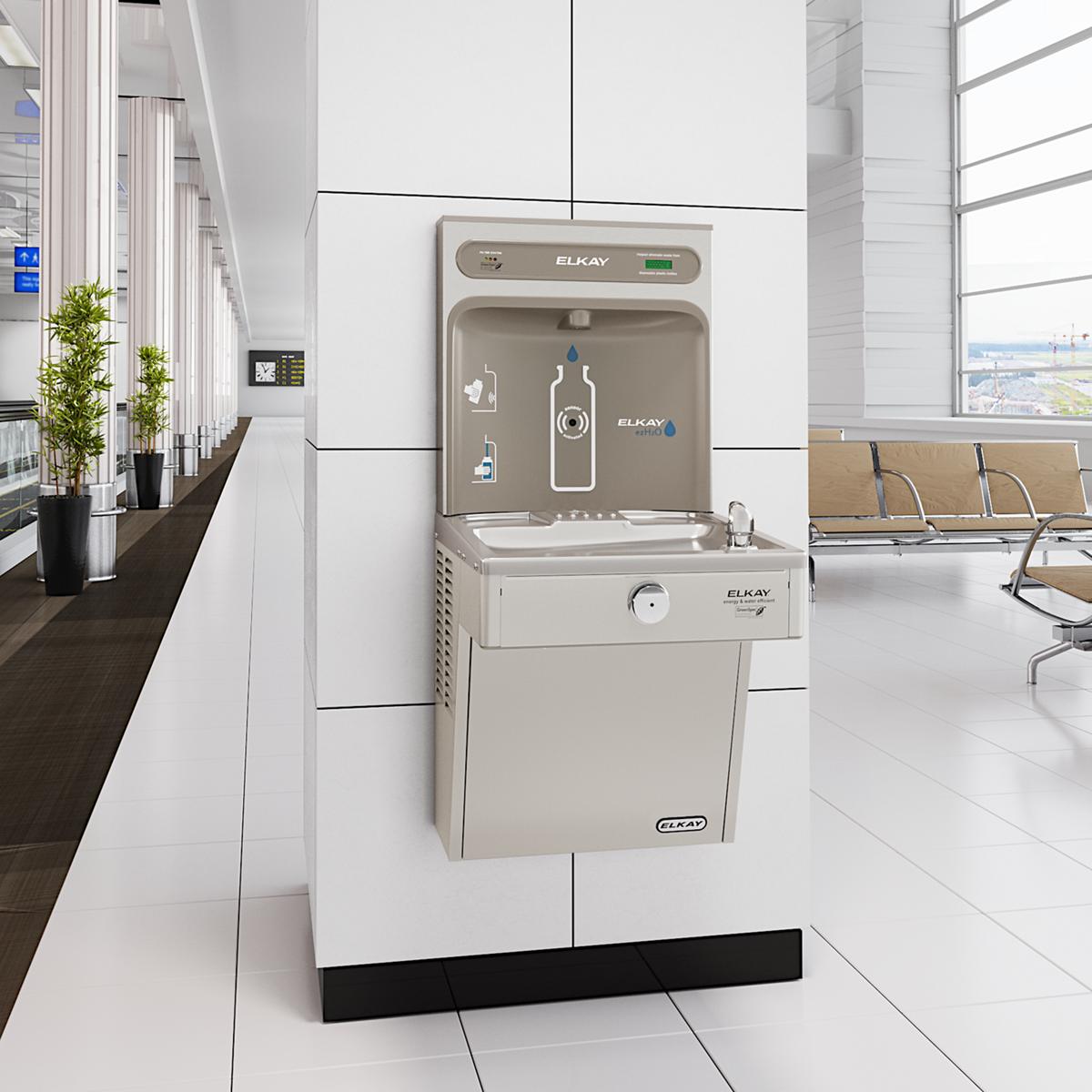Elkay stainless steel bottle filling station and water cooler with filtered refrigerated dispenser mounted on white wall.
