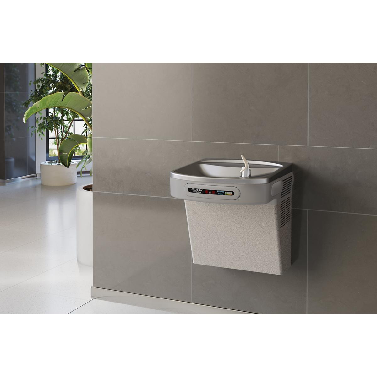 Wall-mounted light gray granite water cooler with hands-free activation and integrated filtering system.