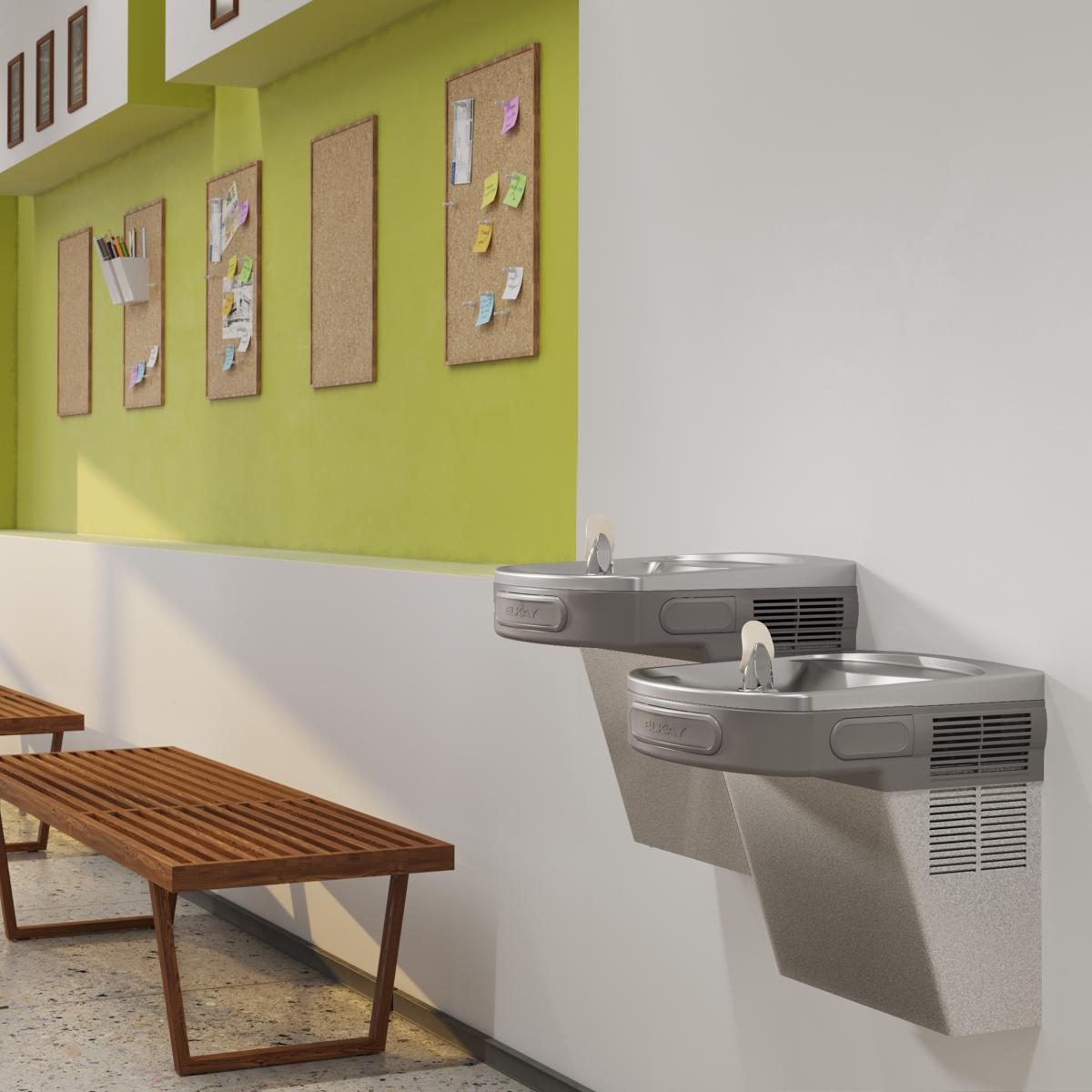 Light gray granite wall-mounted bi-level water cooler with two drinking fountains at different heights installed in instituti