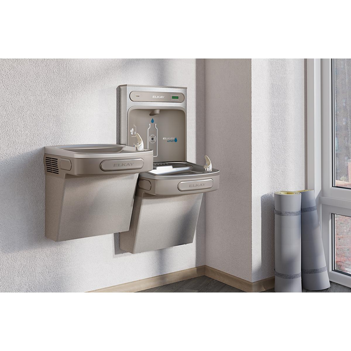 Light gray Elkay water cooler with dual drinking fountains mounted on wall and bottle filling station mounted above.