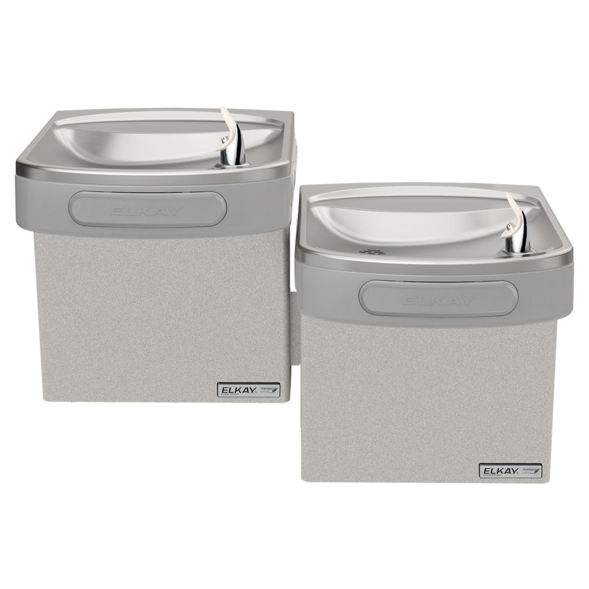 Two wall-mounted light gray granite water coolers with stainless steel bowls and faucets, one positioned higher than the othe