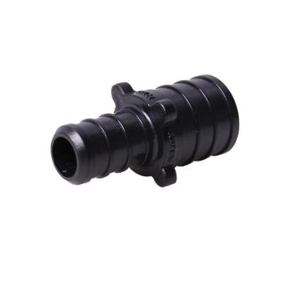 Black plastic PEX coupling with two different sized barbed ends for connecting 1 inch and 3/4 inch tubing.