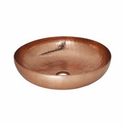 Polished copper vessel sink with hammered texture finish and single drain hole.