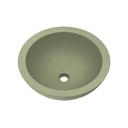 Sage green round concrete sink with single drain hole, viewed from above.
