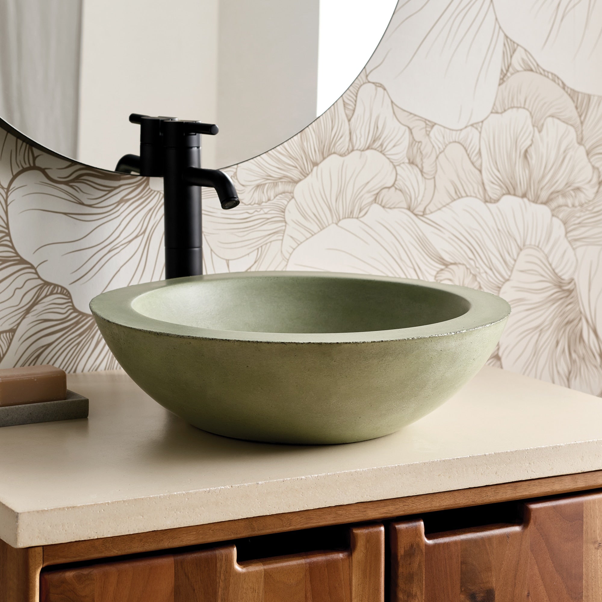 Sage green concrete vessel sink with black tall-spout faucet on white countertop.