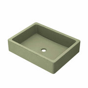 Sage green rectangular concrete sink with single drain hole and sloped interior walls.