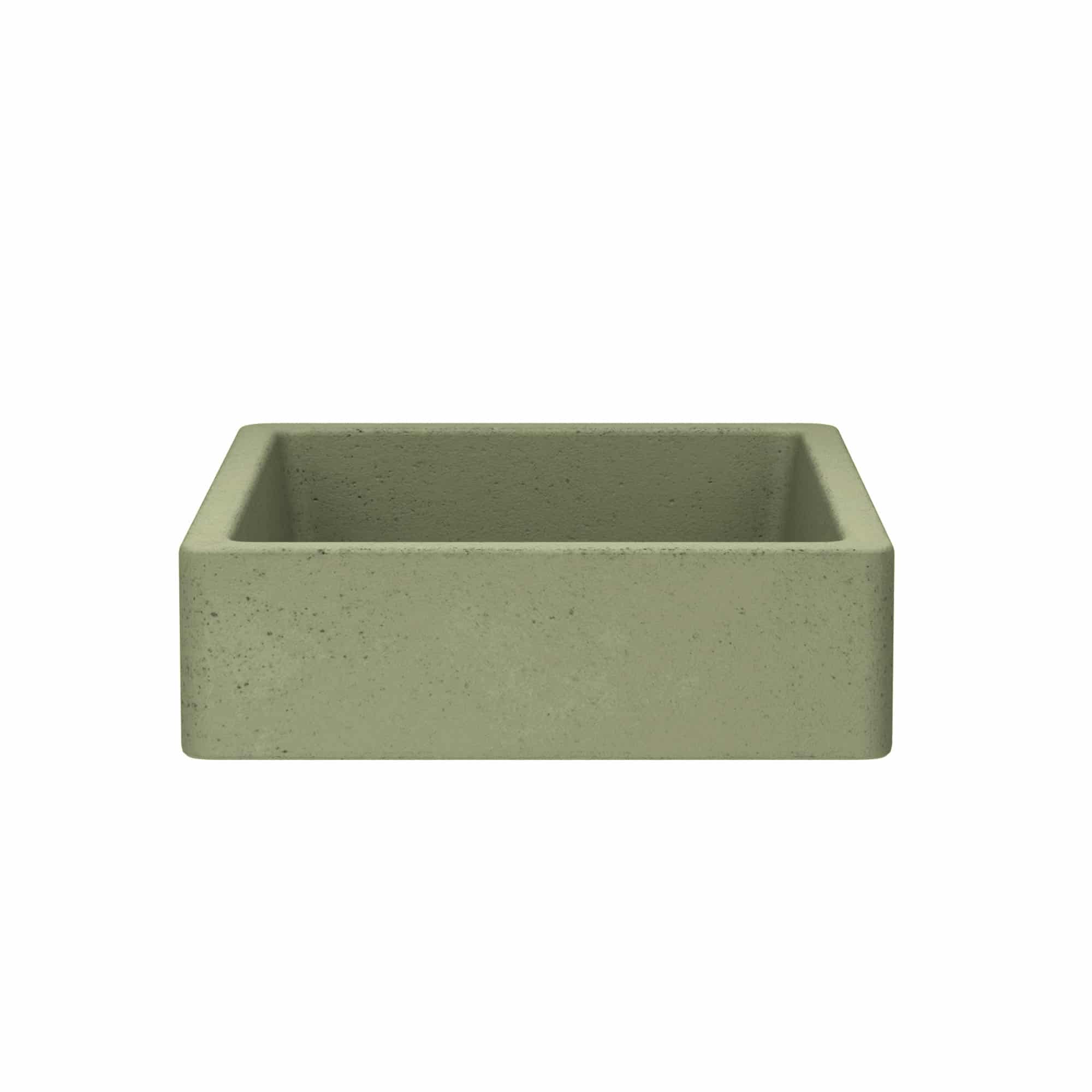 Sage green concrete apron-front sink with textured surface and rounded corners.
