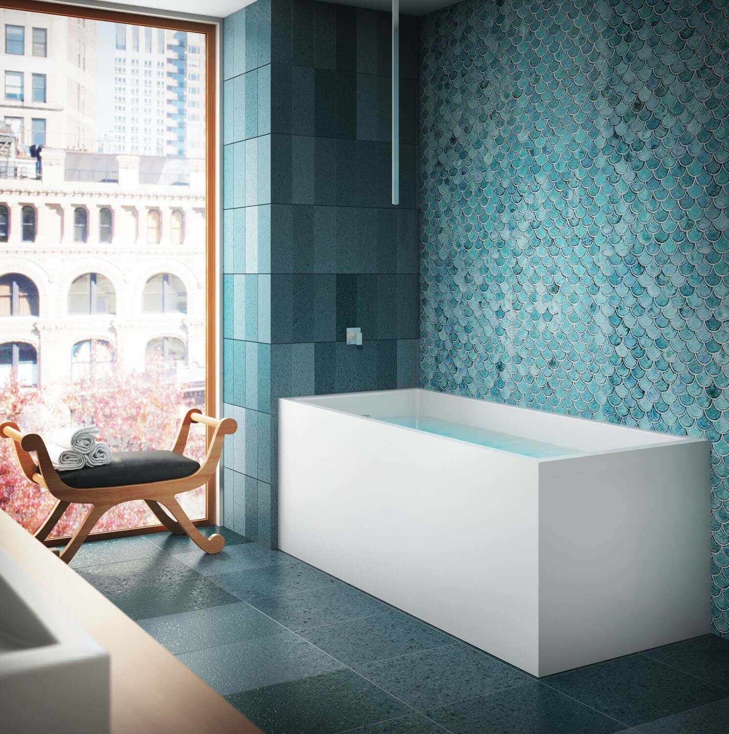White rectangular freestanding soaker bathtub in modern bathroom with teal tile walls and wooden bench.