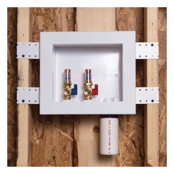 Copper washing machine outlet box with dual ball valves and water hammer arrestor mounted in white plastic wall box between w