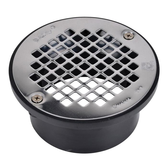 Stainless steel drain strainer with grid pattern openings and mounting screws on dark PVC base.