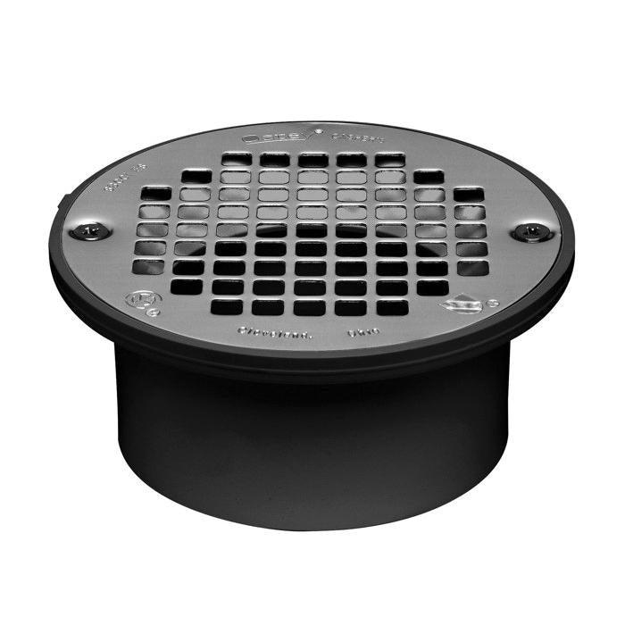 Stainless steel strainer with rectangular perforations mounted on black PVC drain body with mounting holes.