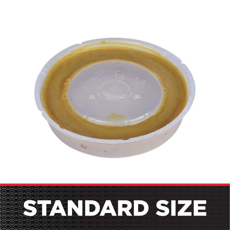 Tan wax gasket ring with white plastic center cap and three small mounting holes.