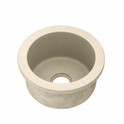 Sand-colored round concrete sink with single drain hole, viewed from above.