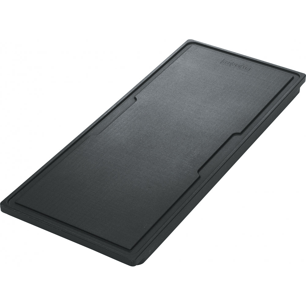 Black rectangular cutting board with grooved edges and juice channel, viewed from above at an angle.