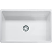 White fireclay apron front single bowl sink with chrome drain strainer visible from above.