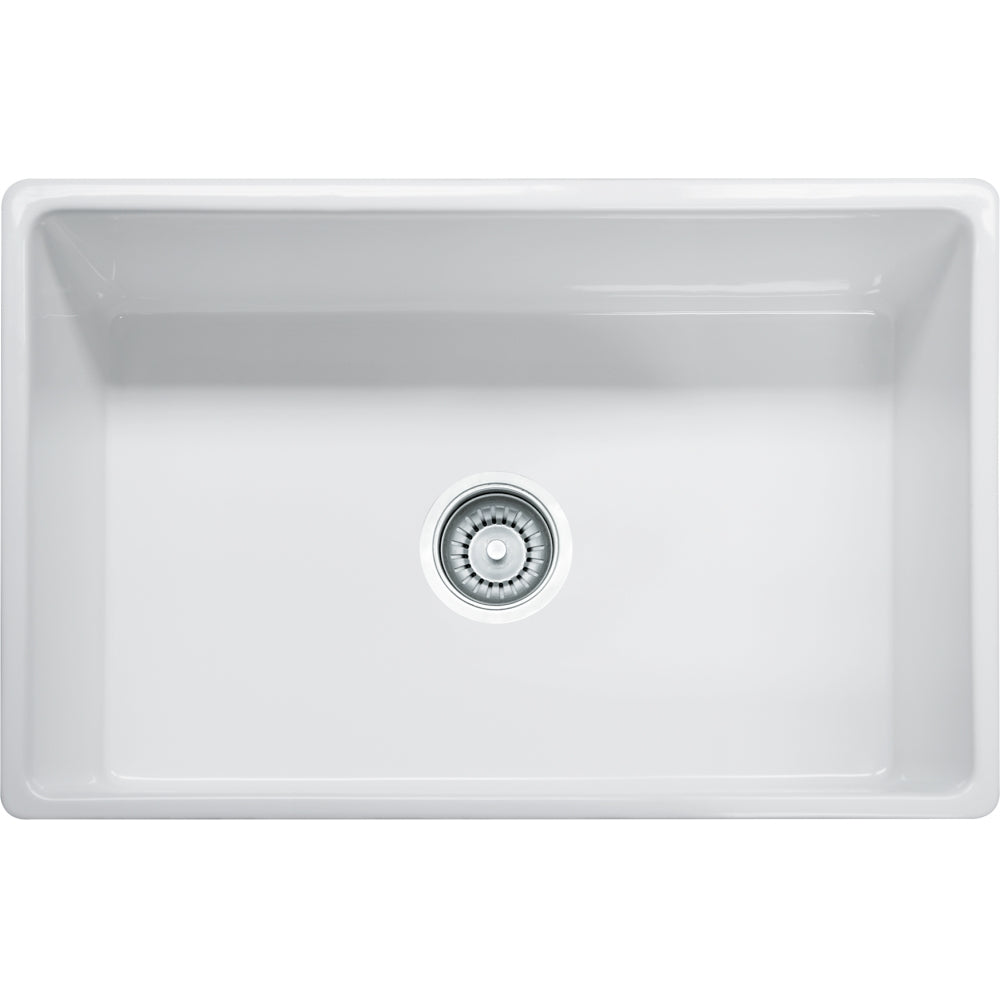 White fireclay apron front single bowl sink with chrome drain strainer visible from above.
