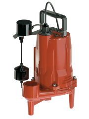 Red and black submersible grinder pump with vertical float switch, handle, and attached power cord.