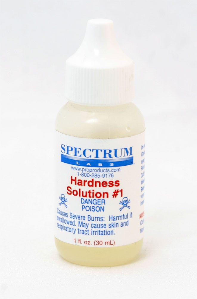 Spectrum Labs Hardness Solution #1 in clear plastic bottle with white dropper cap and yellow liquid inside.