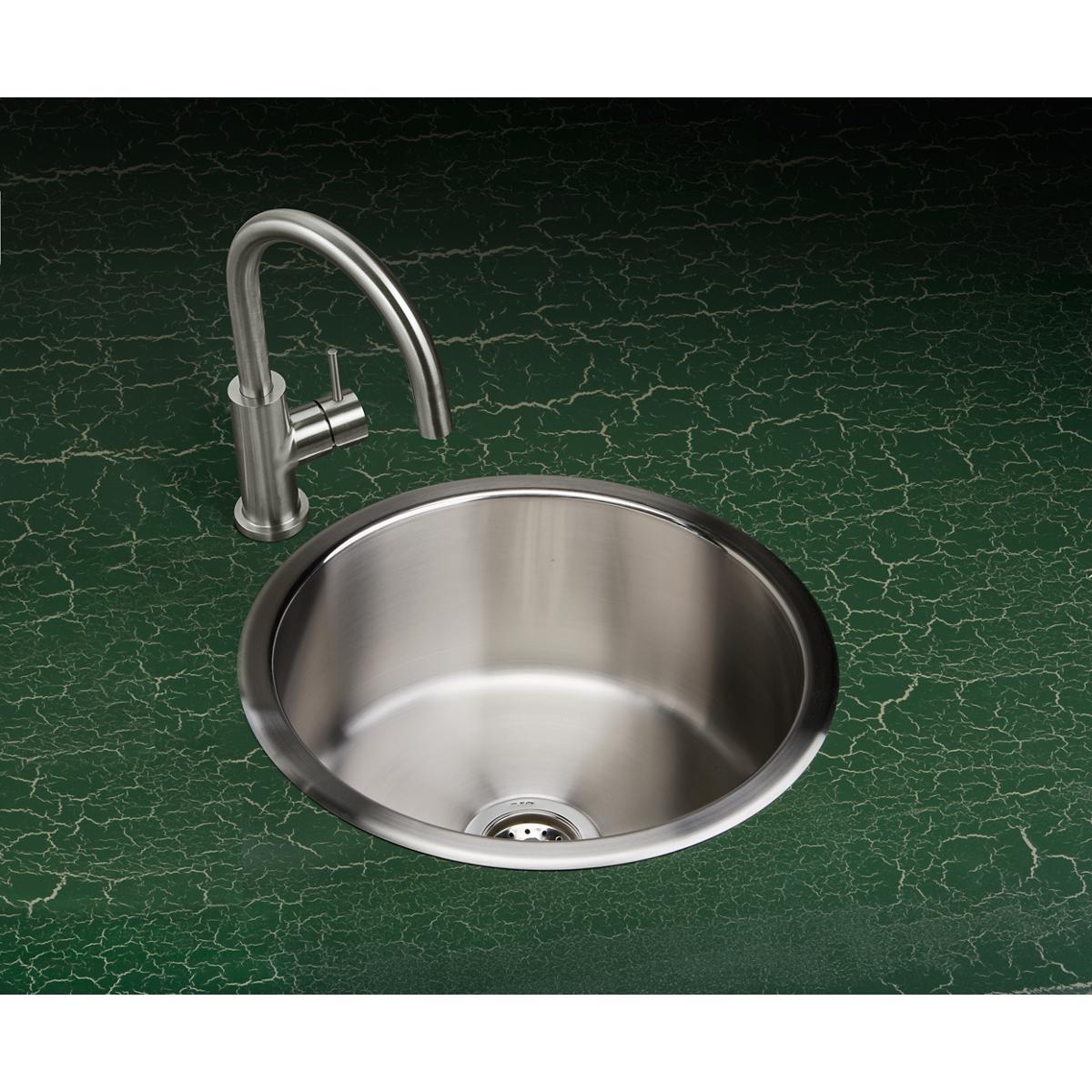 Stainless steel round drop-in sink with single bowl and chrome curved faucet mounted on green marble countertop.