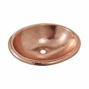 Polished copper oval sink with textured hammered surface and single drain hole.
