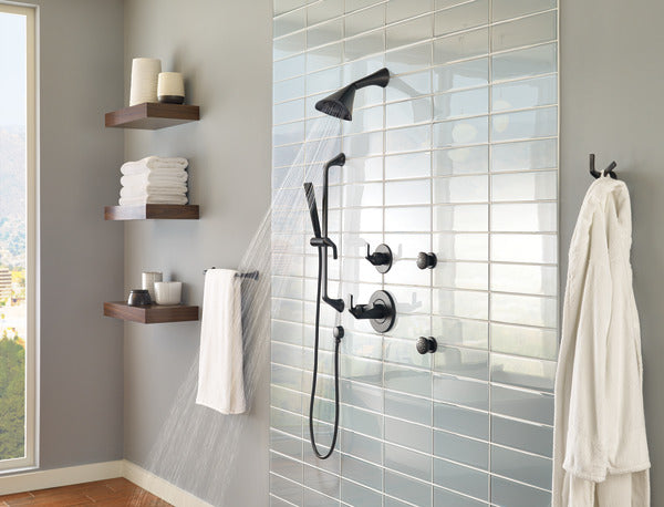 Matte black diverter trim with overhead showerhead, handheld spray, and three body jets mounted on shower wall.