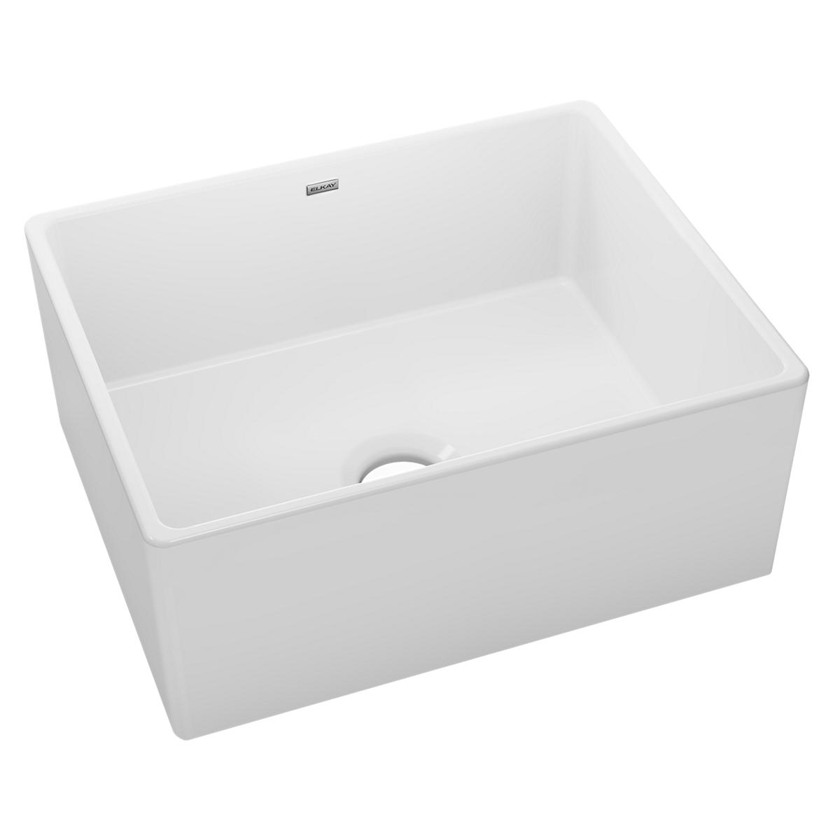 White fireclay farmhouse sink with single bowl and drain hole, front-facing installation.