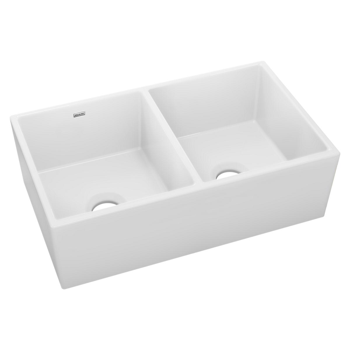 White fireclay farmhouse sink with two equal rectangular bowls and drain openings.