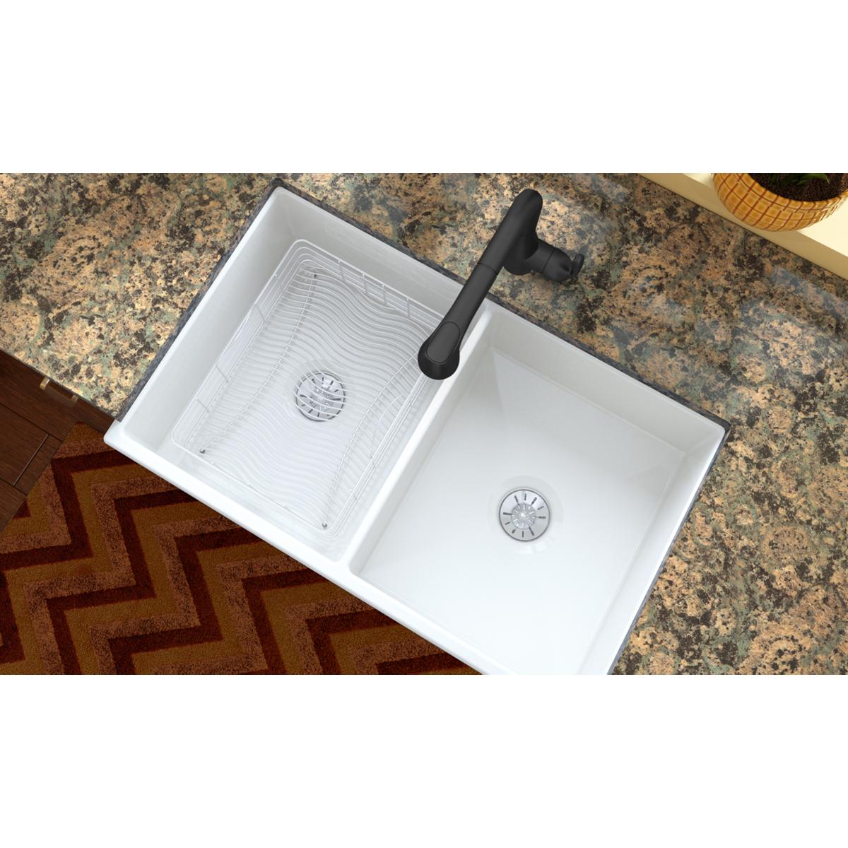 Stainless steel rinsing basket with ribbed bottom surface, positioned in left sink compartment next to black faucet.