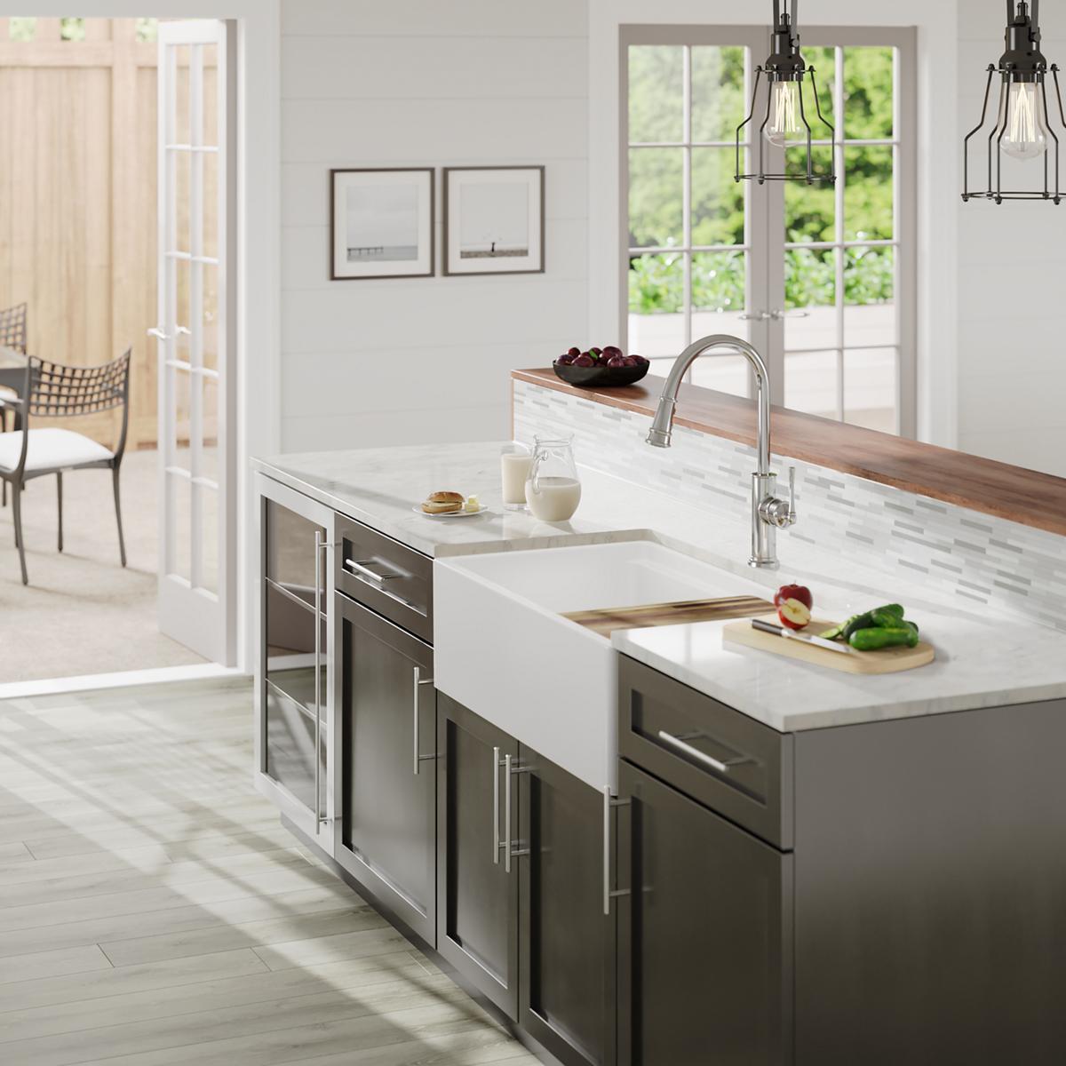 White fireclay double bowl farmhouse sink with divider installed in kitchen island countertop.
