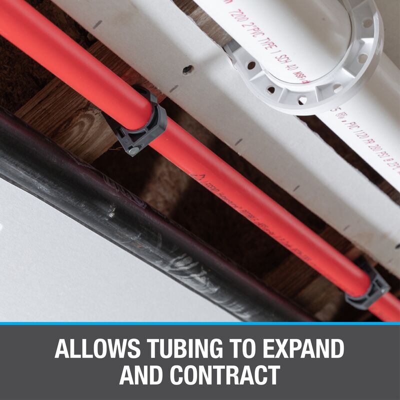 Steel half clamp with barbed nail securing red tubing to white plastic fixture.