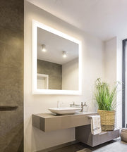 Square lighted bathroom mirror with white LED border frame mounted above vessel sink.