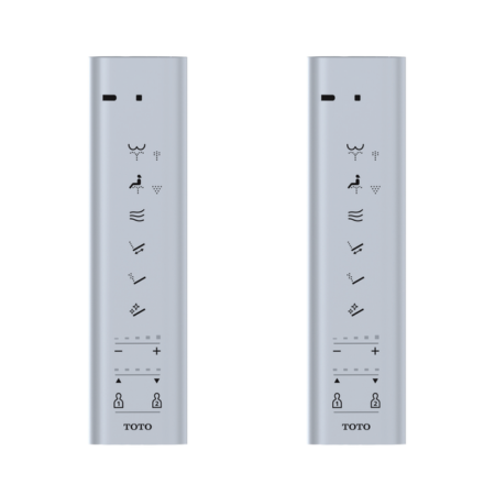 Two silver Toto remote controls with function buttons and mounting bracket slots displayed side by side.