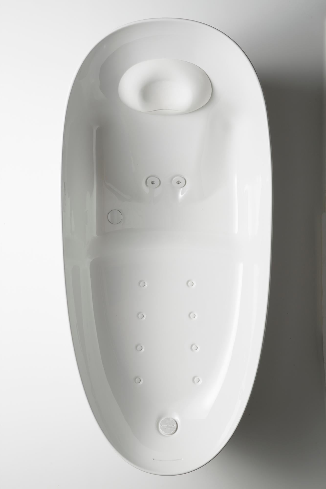 White oval bathtub with head rest, jet controls, and hydro massage jets visible from above.