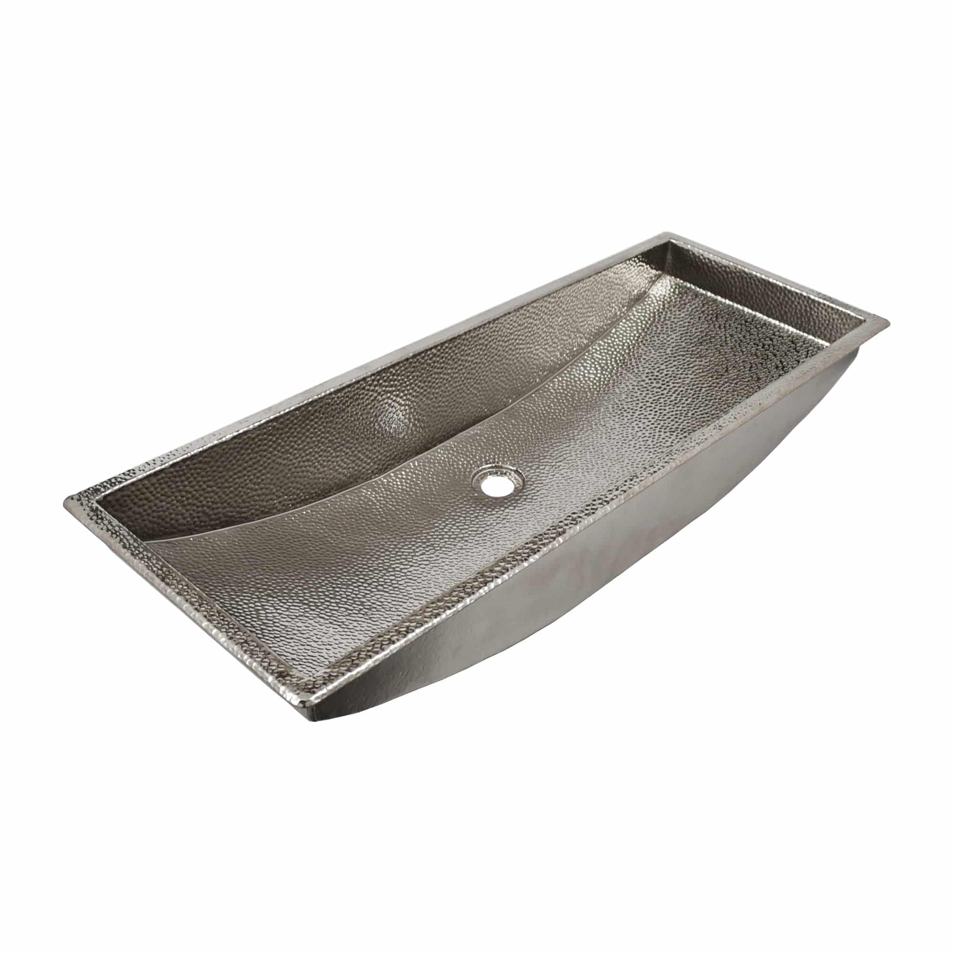 Polished nickel trough sink with hammered interior surface and single drain hole.