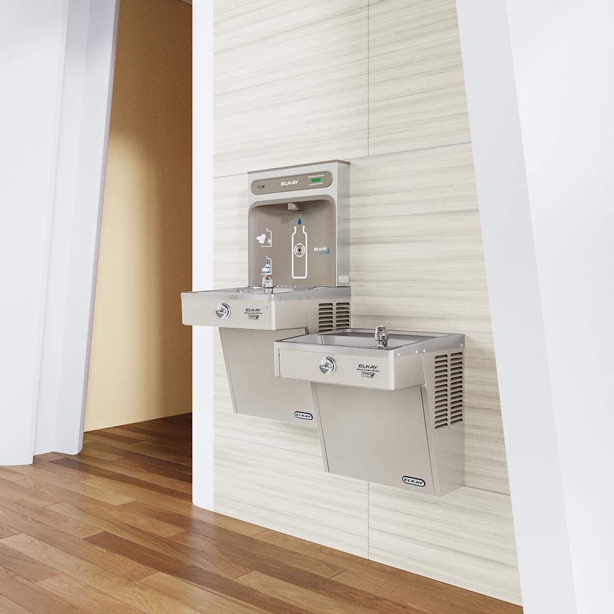 Stainless steel wall-mounted water cooler with upper bottle filling station and lower drinking fountain mounted in hallway.