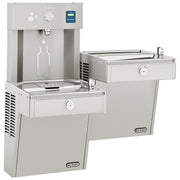 Stainless steel dual-station water cooler and bottle filling station with bi-level drinking fountains and refrigerated basin.