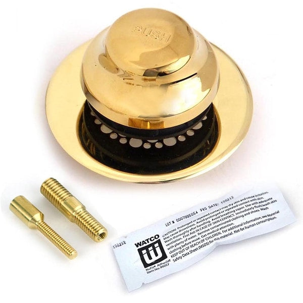 Polished brass foot-actuated tub stopper with grid strainer, two brass fittings, and instruction sheet.