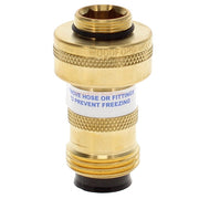 Brass cylindrical backflow preventer with textured grip bands, threaded connections top and bottom, and white warning label.