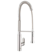Chrome kitchen faucet with single handle, coiled pull-out spray head, and tall arched spout.