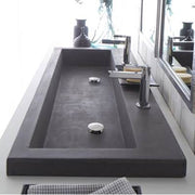 Rectangular slate trough sink with single faucet mounted in modern bathroom vanity.