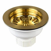 Brushed gold basket strainer with white plastic base and radiating slots, 3.5 inch diameter.