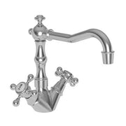 Chrome bar faucet with curved spout, cross handles, and ornamental base featuring traditional Chesterfield styling.