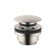 Brushed nickel push-open drain with flat circular cap and cylindrical body for sink installation.