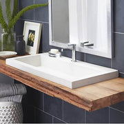 Pearl white rectangular trough bathroom sink with chrome faucet mounted on wooden countertop.