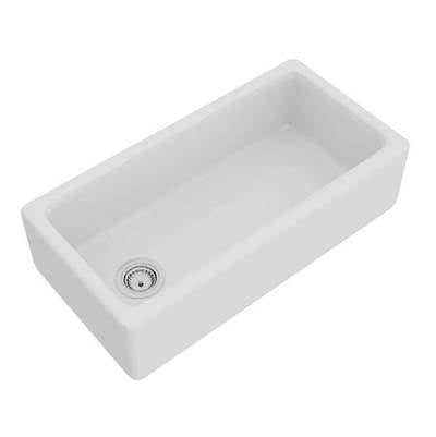 White fireclay apron front kitchen sink with single bowl and drain opening.