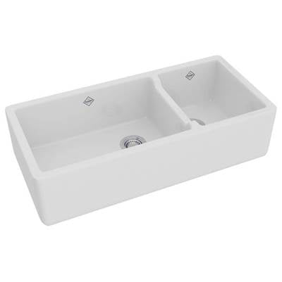 White fireclay apron front kitchen sink with 1.5 bowls and divider, shown from above angle.